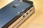 Gold iPhone 5S hardware dummy appears aside standard black and white