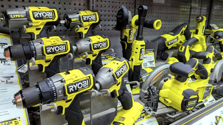 A store shelf with several Ryobi tools