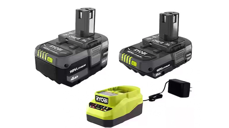 A stock image of a Ryobi charger and two batteries