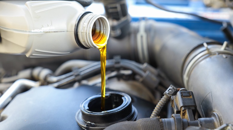 Motor oil being poured into an engine