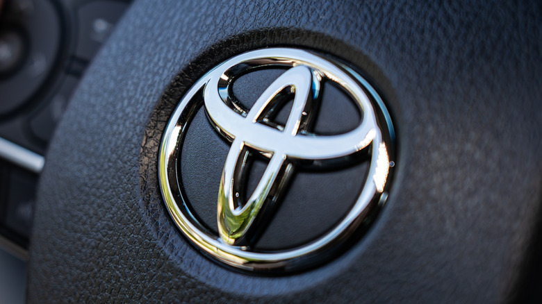 The Toyota badge on a steering wheel.