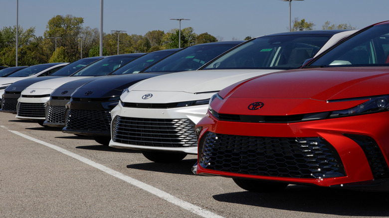 Multiple Toyota vehicles parked at a dealership.