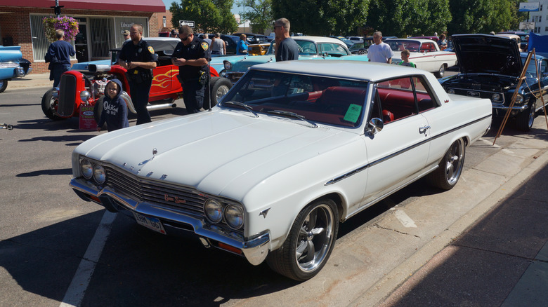 White 1965 Buick Skylark Gran Sport seen from left front at outdoor car show