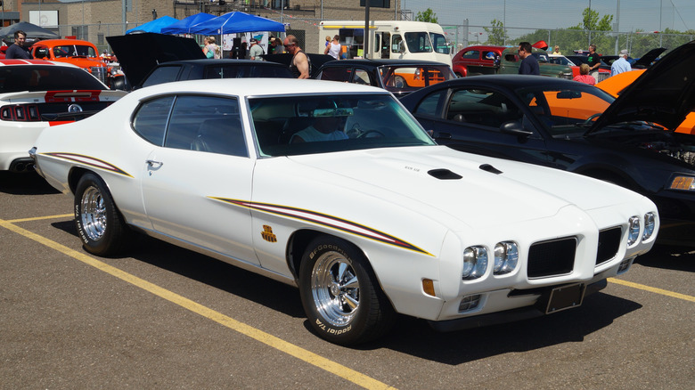 White 1970 Pontiac GTO Judge seen from right front parked at outdoor car show