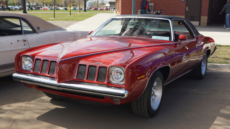 Red 1973 Pontiac Grand Am coupe seen from front left