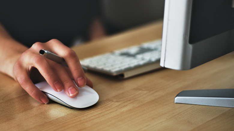 person using Apple Magic mouse