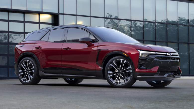 Red Chevrolet Blazer EV by office building.