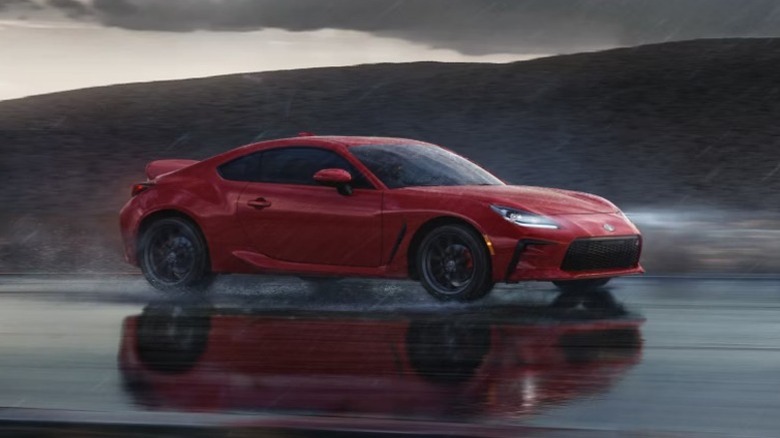 A red 2025 Toyota GR86 on a wet road