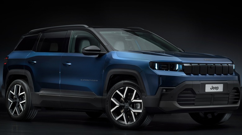 Blue 2026 Jeep Compass First Edition Pacific seen from right front against dark studio background