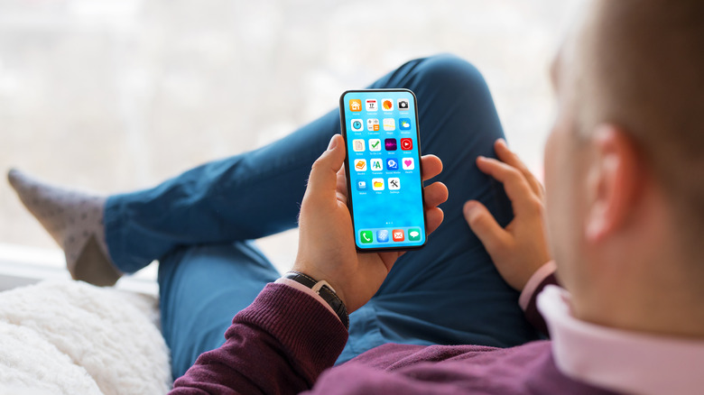 Man using smartphone at home