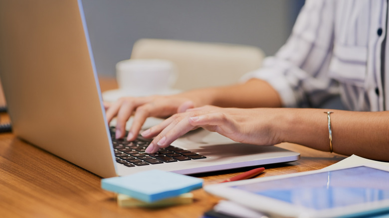 A person writing on a computer