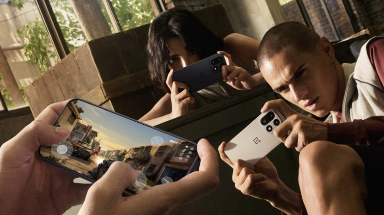 Three people playing games on OnePlus 15