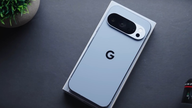 Light blue Google Pixel 10 Pro face-down on a dark gray table