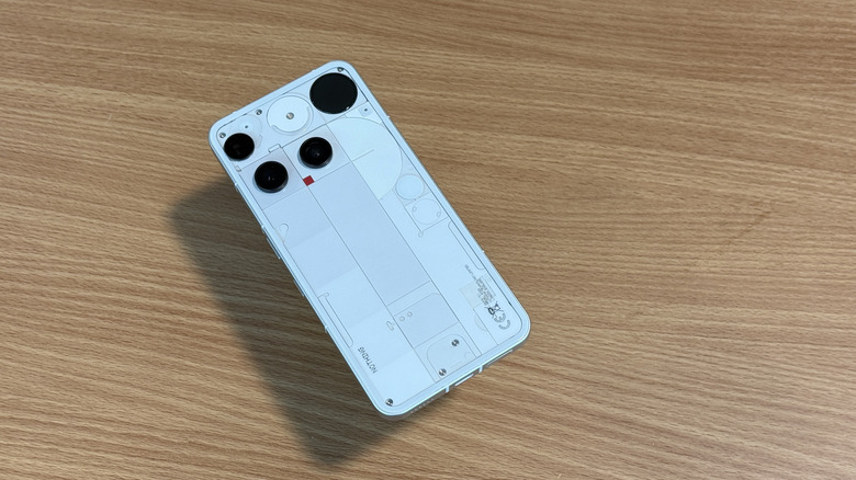 White Nothing Phone (3) on a wood table