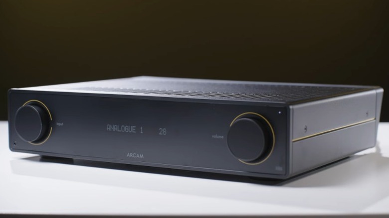 Arcam A5+ ampliifer on a white table.