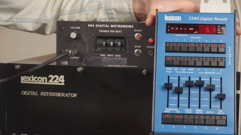 A blue Lexicon 224X digital reverb unit next to other Lexicon gear.