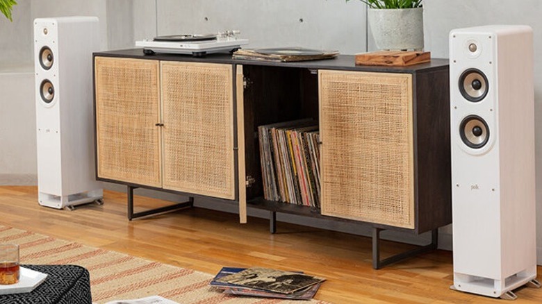 White Polk Audio Signature Elite ES50 floorstanding speakers in a living room.