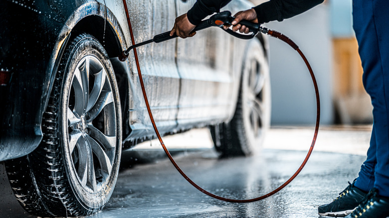 technician washing a car before working on it