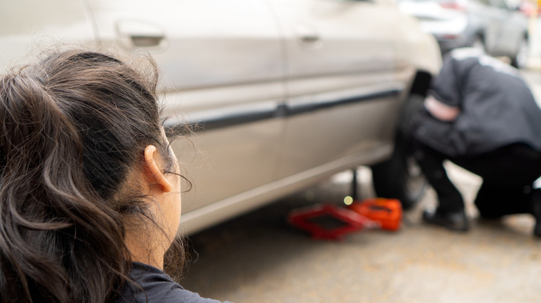 watching over car repair work