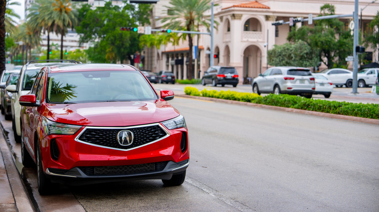 Red Acura RDX parked on the street.