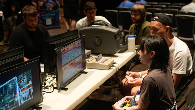 A group of people playing retro games at a table together