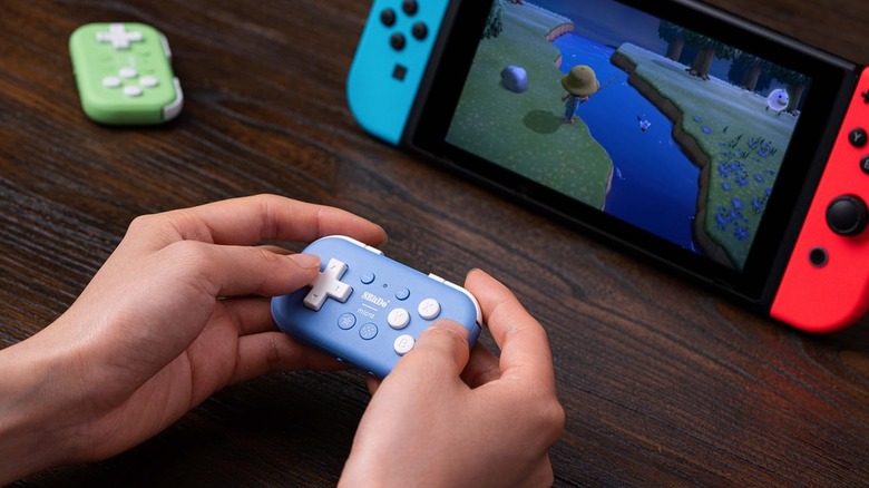 An 8BitDo micro controller being used to play on a Nintendo Switch