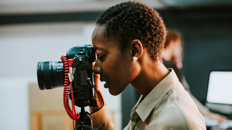Photographer looking through DSLR viewfinder