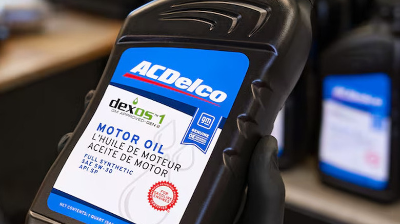 person holding a bottle of motor oil