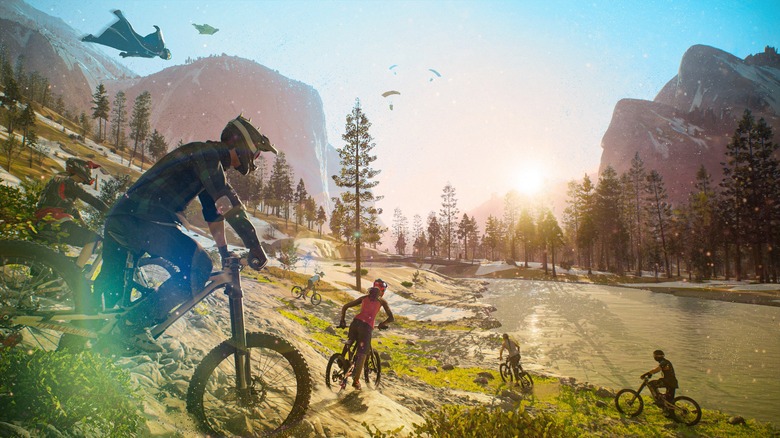 Mountain bike riders and wingsuits in Riders Republic