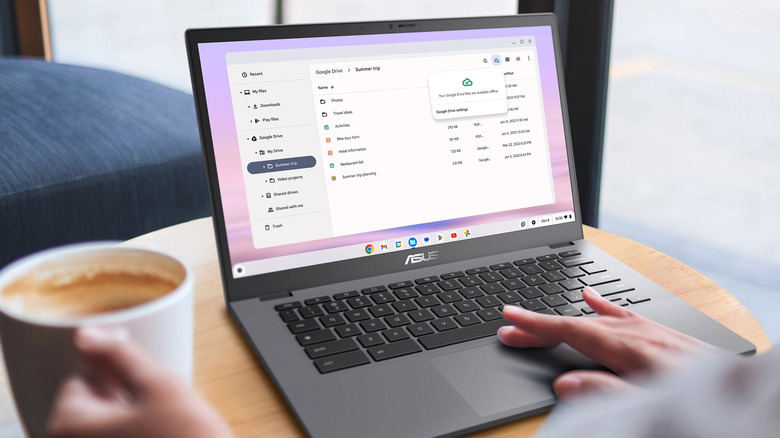 A person working on the Asus Chromebook CX34 on a coffee table