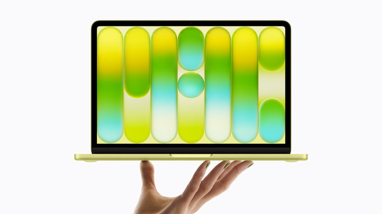 A person holding the MacBook Neo