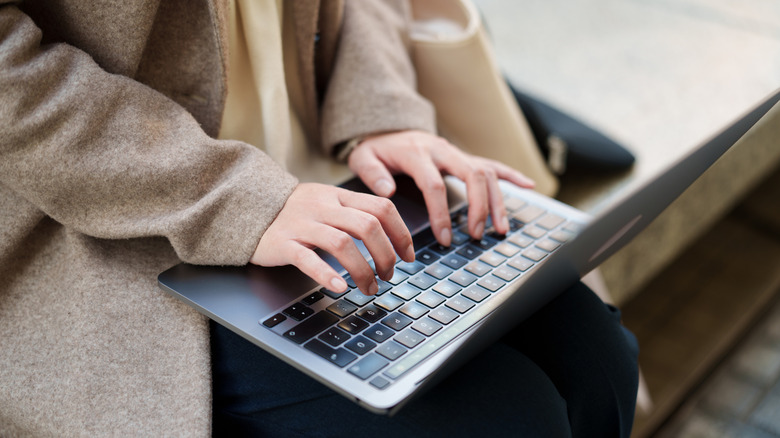 A person working on a laptop kept on their lap