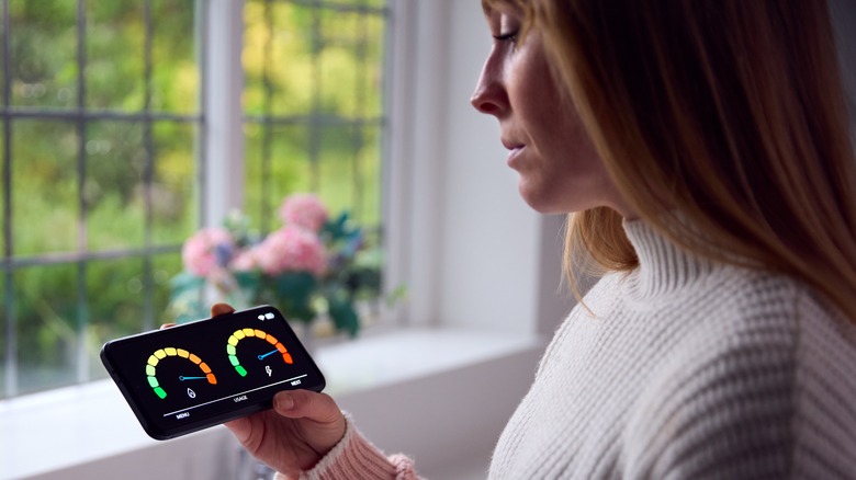 Woman checking smart home features on smartphone