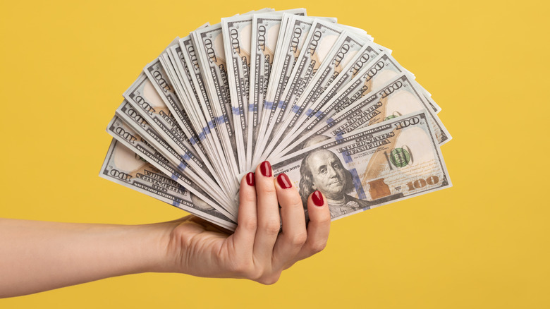 A woman holding money
