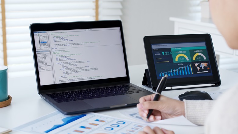 A woman working on some code on a computer