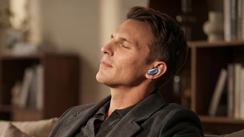 A person closing their eyes and wearing the Anker Soundcore Liberty 5 Pro earbuds