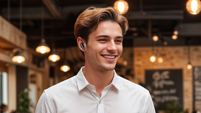 A person wearing the EarFun Air Pro 4+ earbuds with a smile on their face