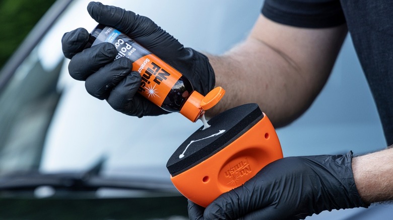 Close up of a person using Nu Finish polishing compound