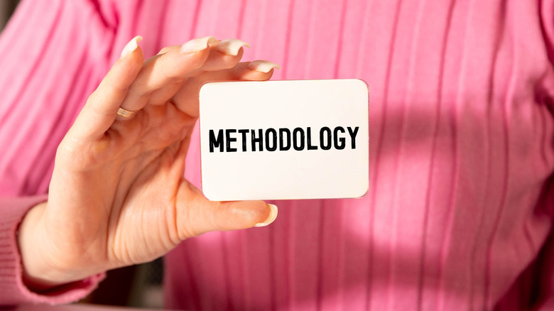 woman holding up methodology card