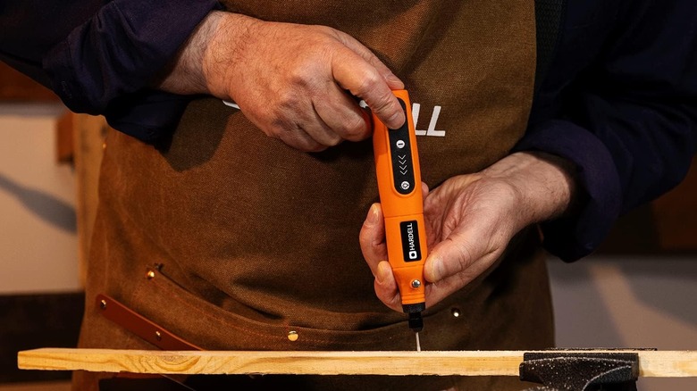 A man is shown using the HARDELL Mini Cordless Rotary Tool.
