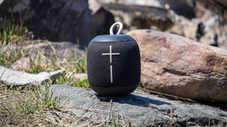 small bluetooth speaker on a rock