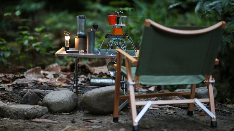 an empty chair in front of coffee camping gear