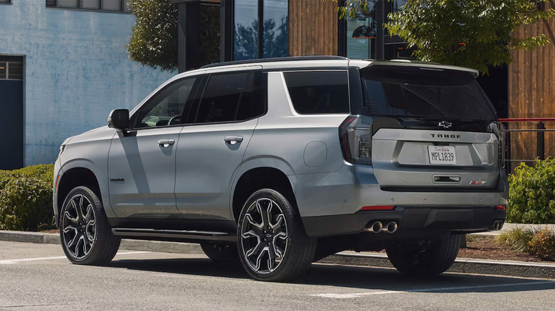 A gray Chevy Tahoe parked on a city street
