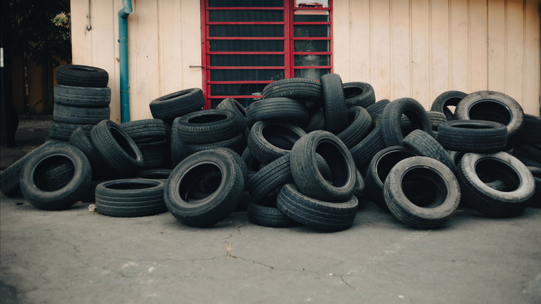 A pile of old tires near a repair shop