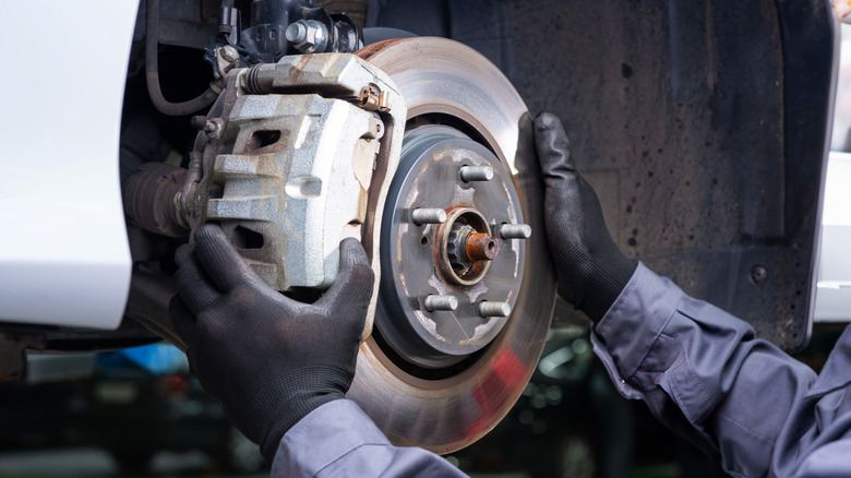 Mechanic working on brakes at shop