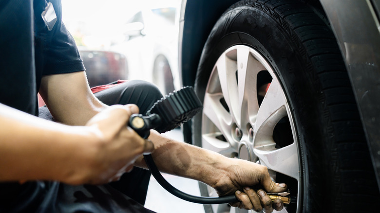 Man checking tire pressure