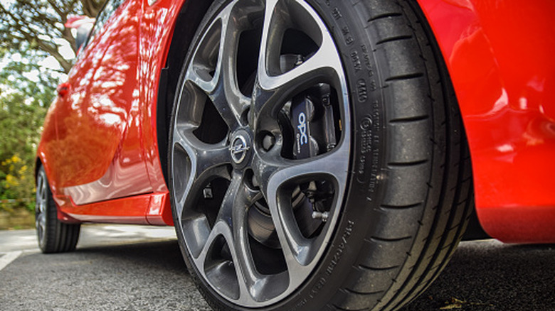 A close-up view of tires slightly extending from the fender