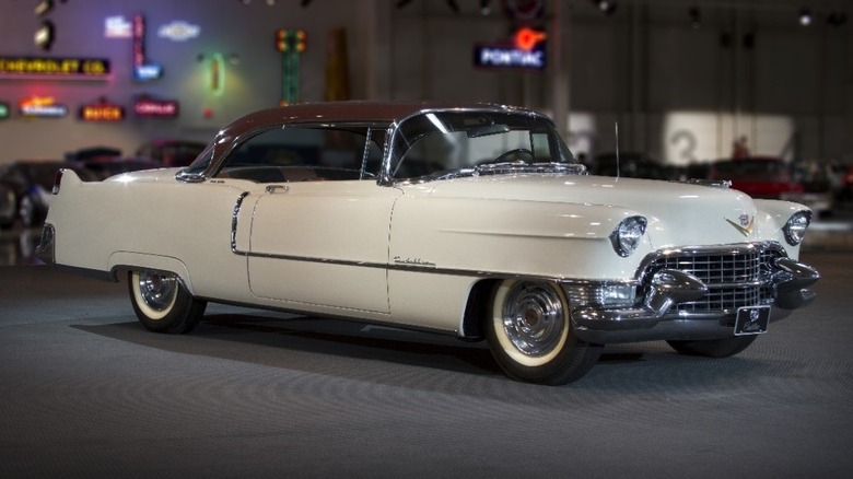 White Cadillac Deville on showroom floor