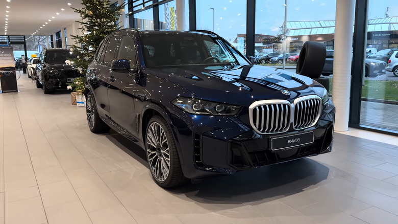 A front end shot of a 2026 BMW X5 in a dealership