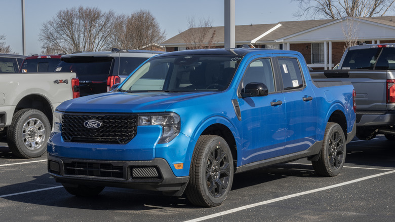 Blue Ford maverick parked in parking lot